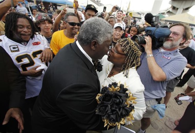 Charlie Vanderpool and Gloria Paige kiss after exchanging vows Thursday outside the Superdome prior to the NFL season opener between the New Orleans Saints and the Minnesota Vikings in New Orleans.